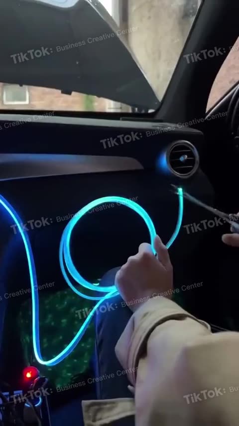 Opening shot: hands coiling LED wire with scissors
