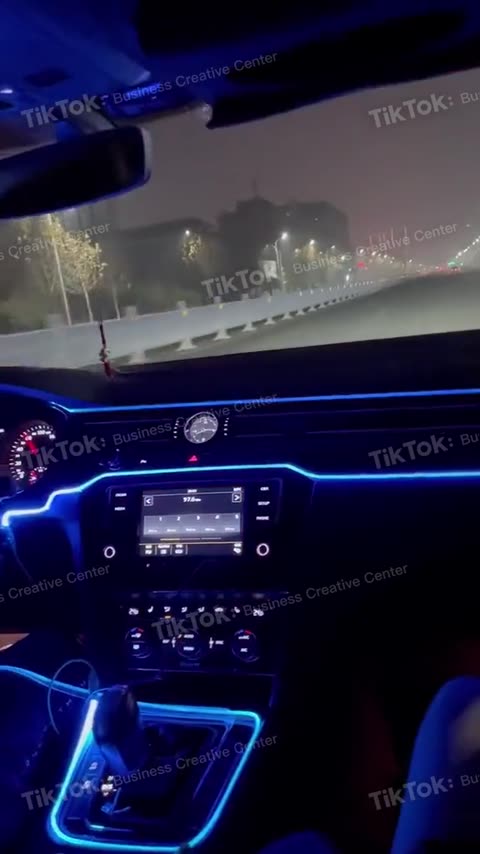 Car dashboard glowing blue during a night drive